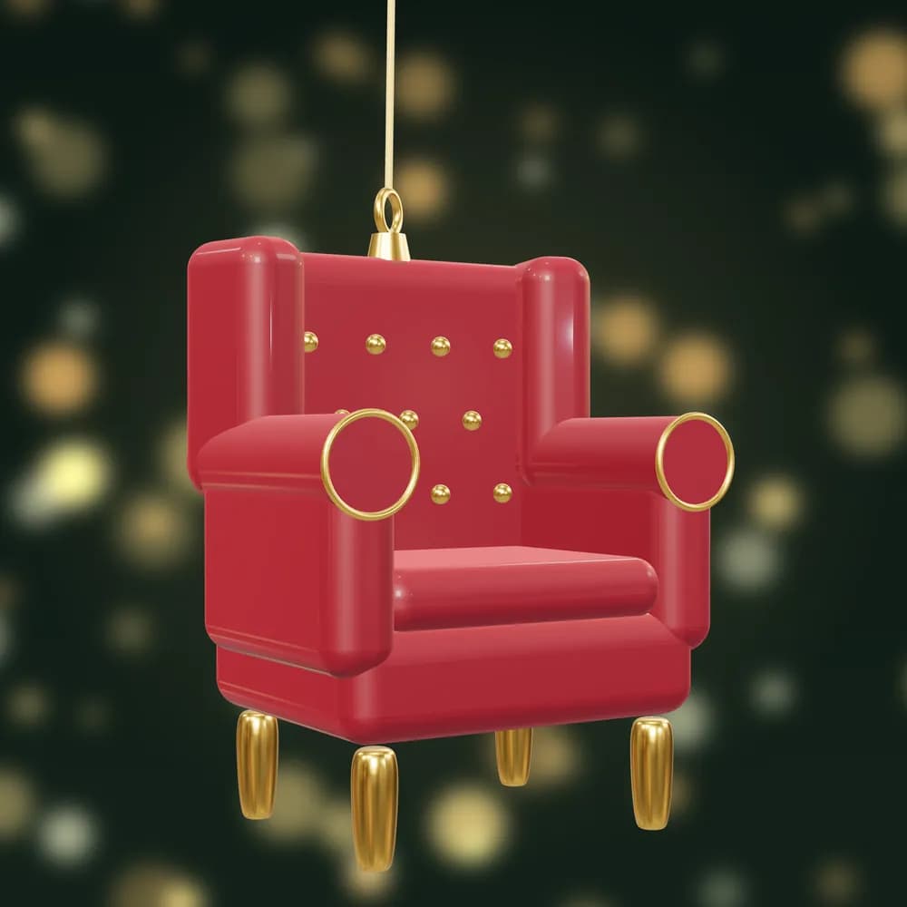 A miniature red wingback armchair bauble with gold buttons and gold legs