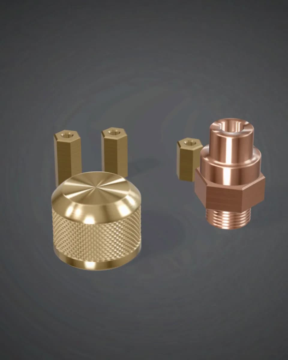 A knurled brass knob, a threaded copper fitting and three brass hex spacers