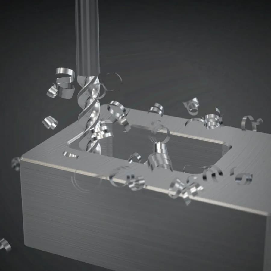 Close-up of a carbide end mill cutting a pocket into a block of aluminium, throwing off curled chips