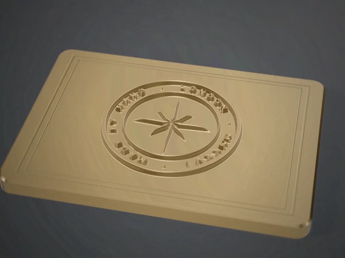 A brass plate with a raised relief medallion and engraved border, machined from solid