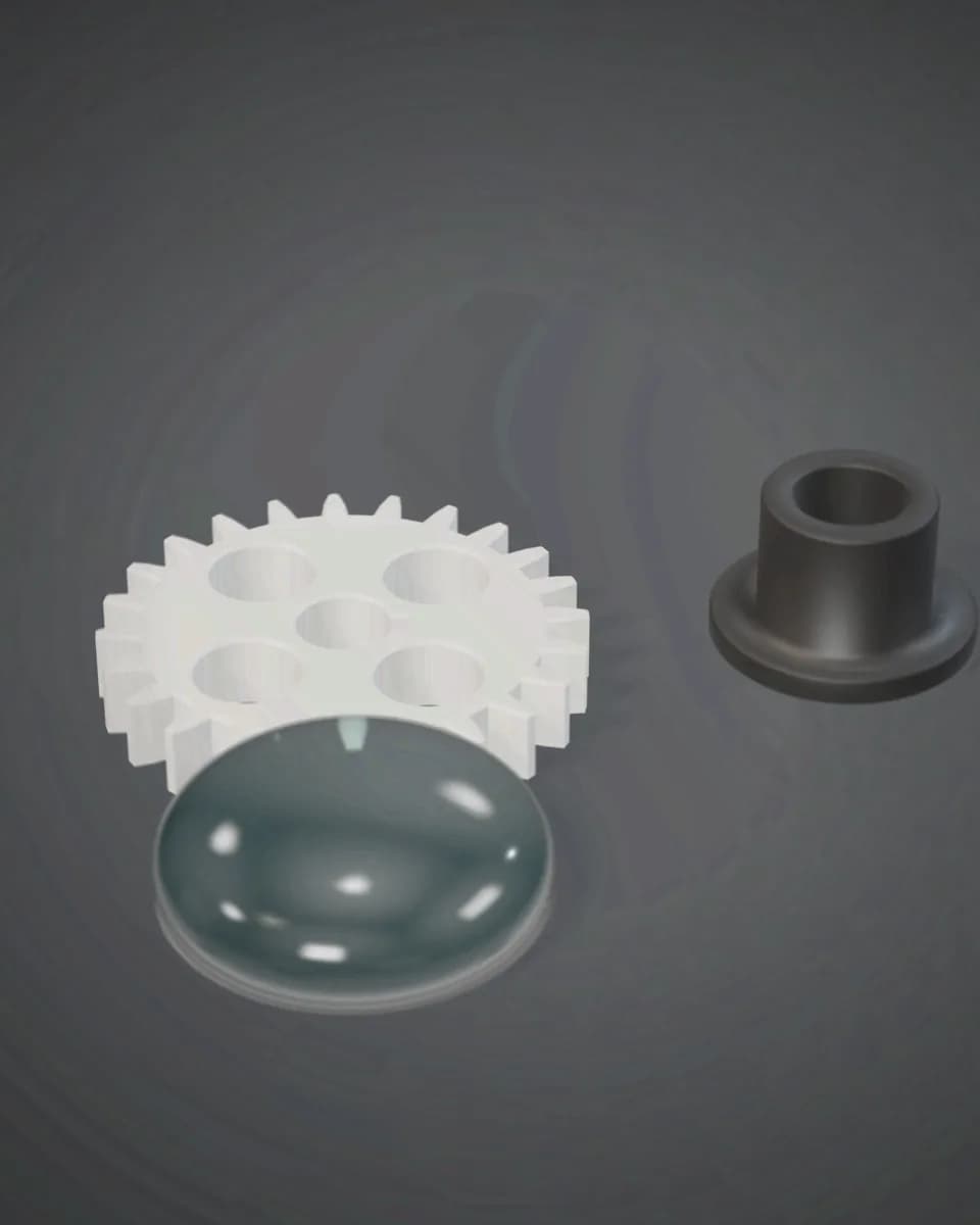 Machined engineering plastic parts: a white acetal gear, a black nylon bush and a clear polished acrylic lens