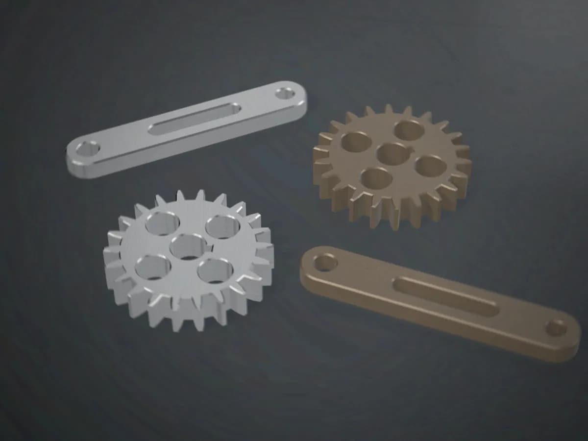 A machined aluminium replacement gear and lever beside the worn originals