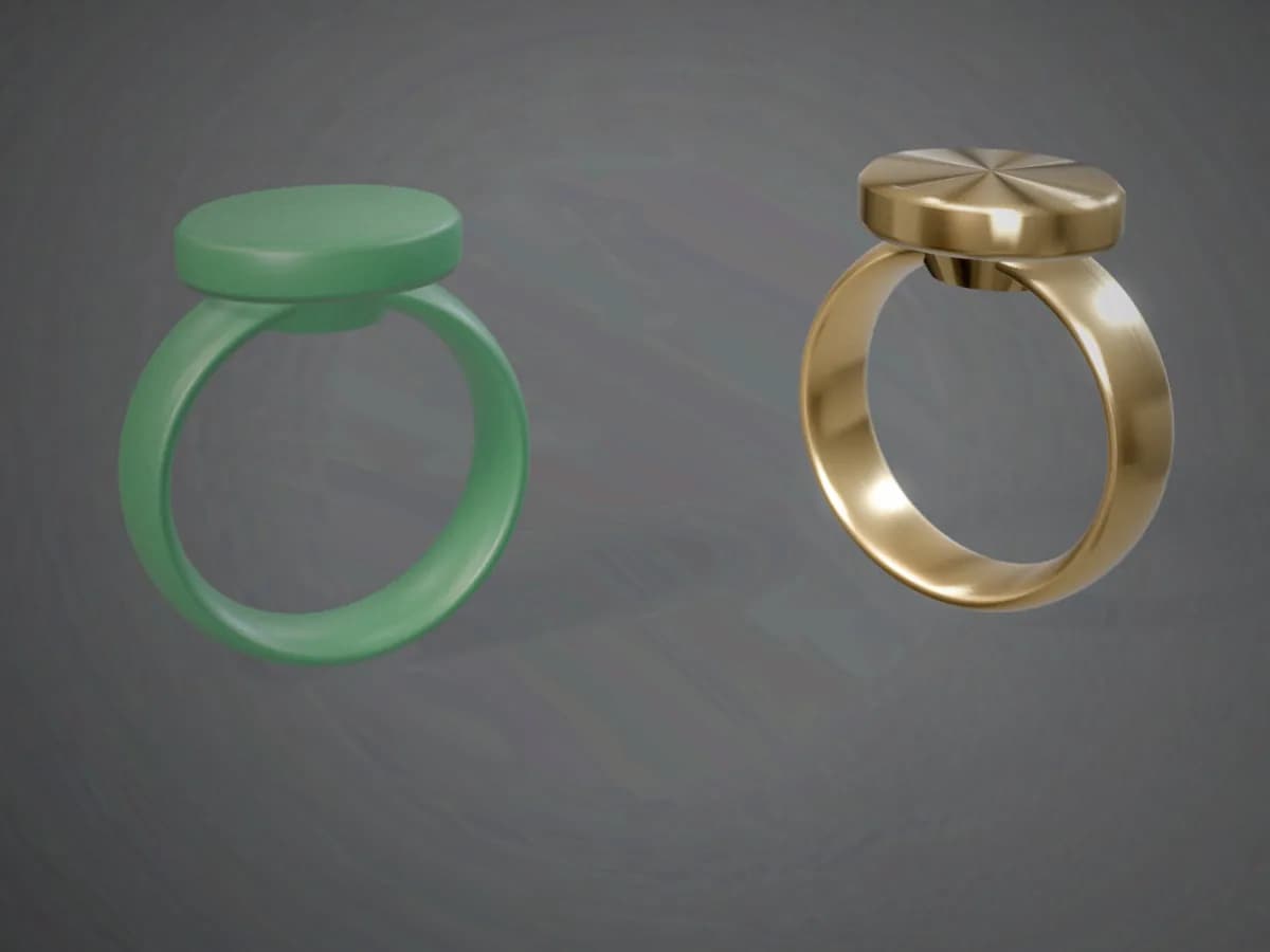 A green jewellery casting wax ring beside the polished brass ring cast from the same design