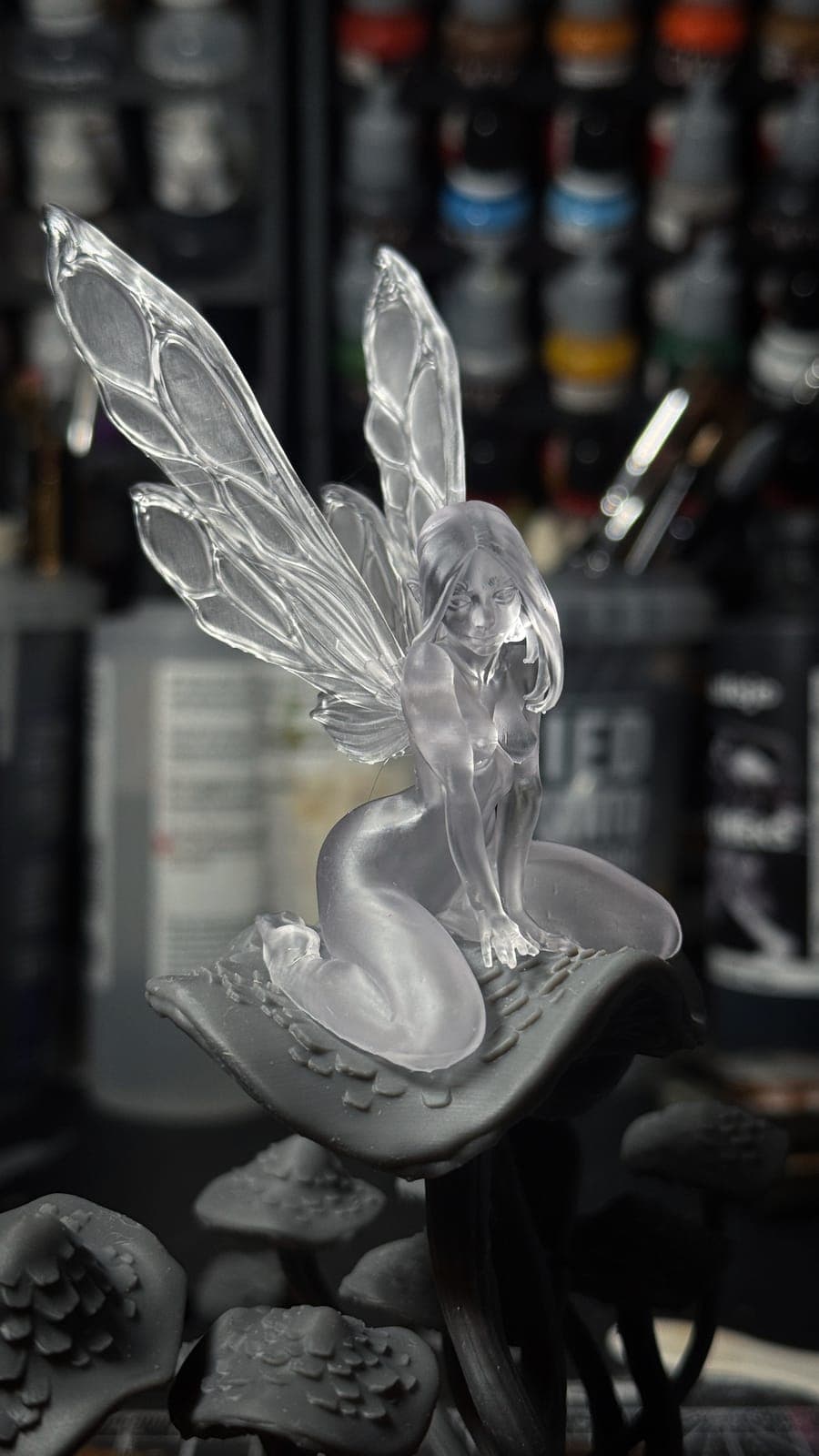 A fairy on a mushroom with wings printed in clear resin