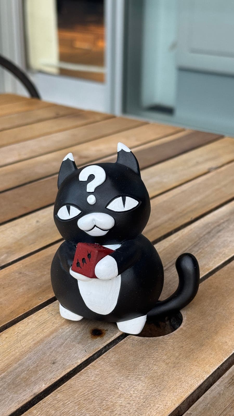 The painted question-mark cat figure from the front