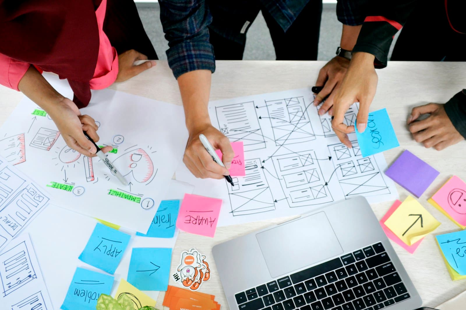 Planning page layouts with sketches and sticky notes