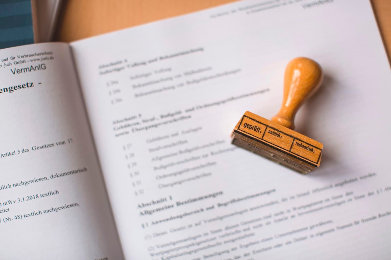 A wooden rubber stamp resting on an open document