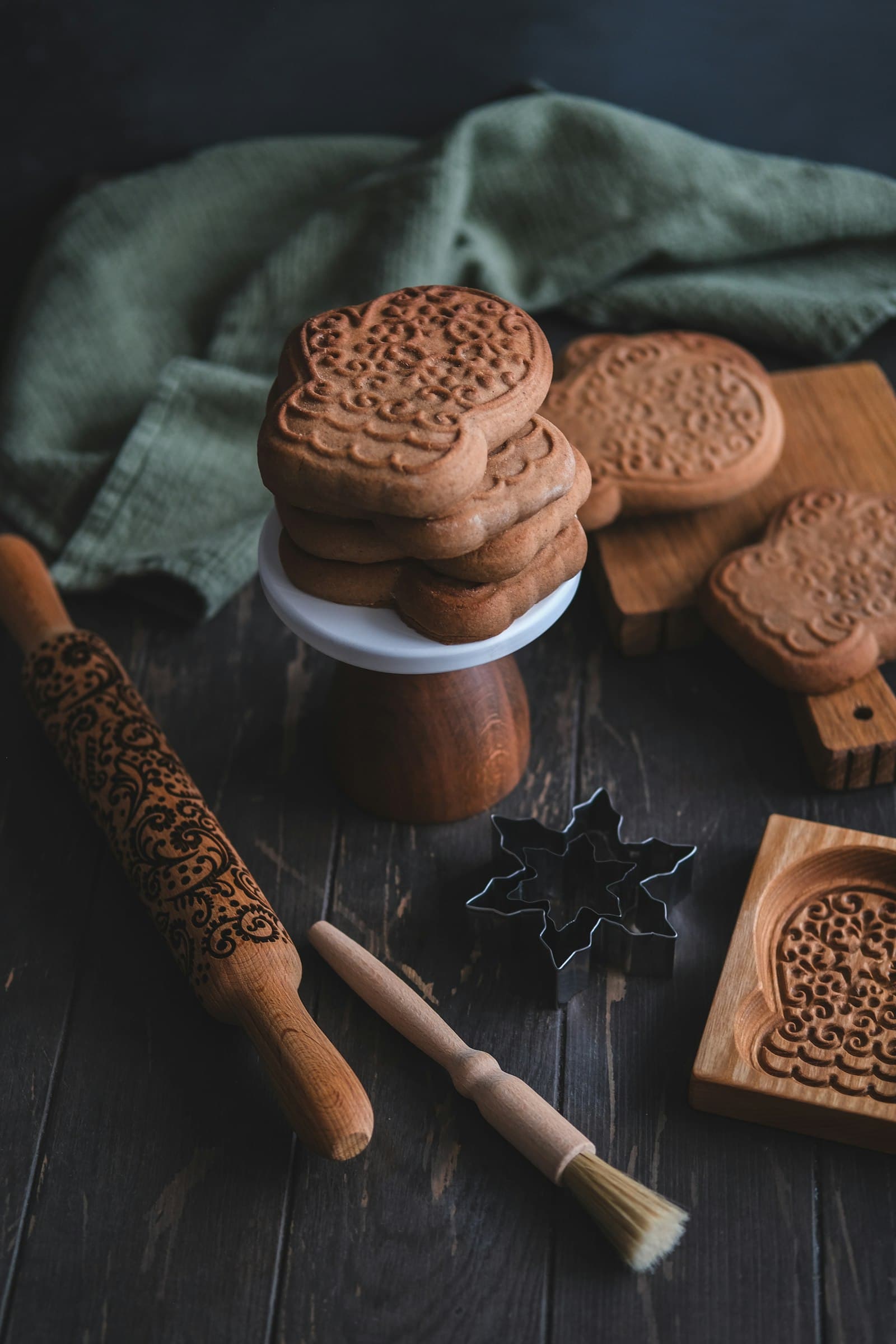 Embossed biscuits beside a patterned roller