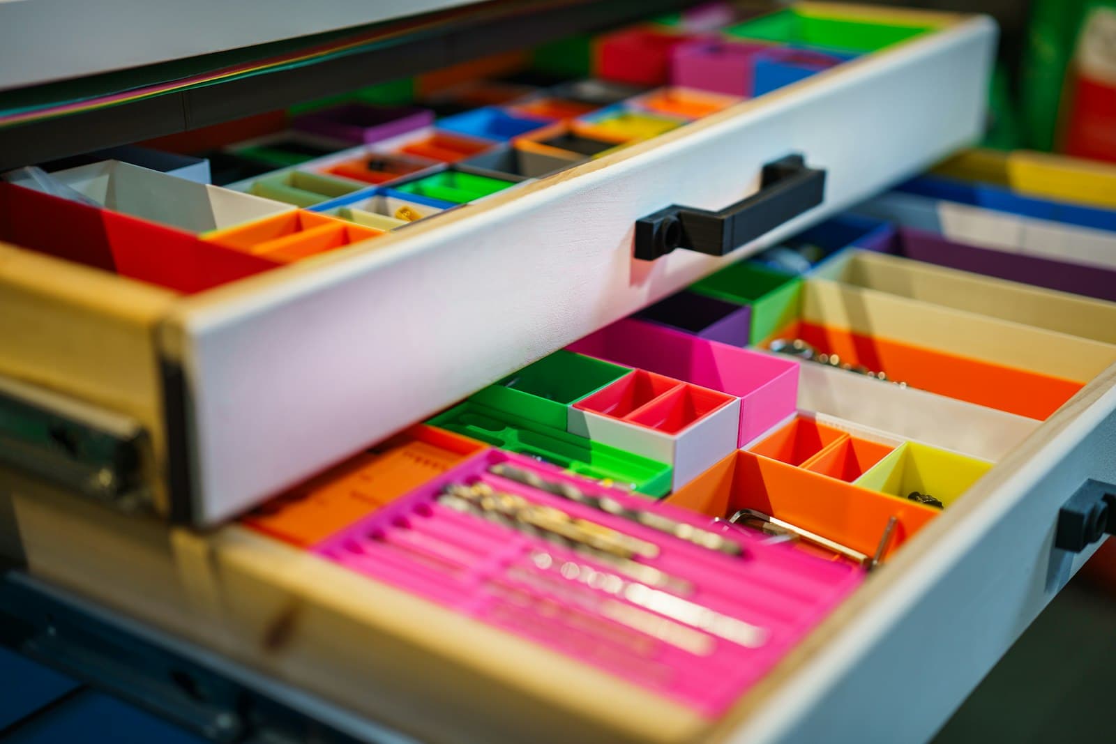 Drawers fitted with colourful 3D-printed organiser trays