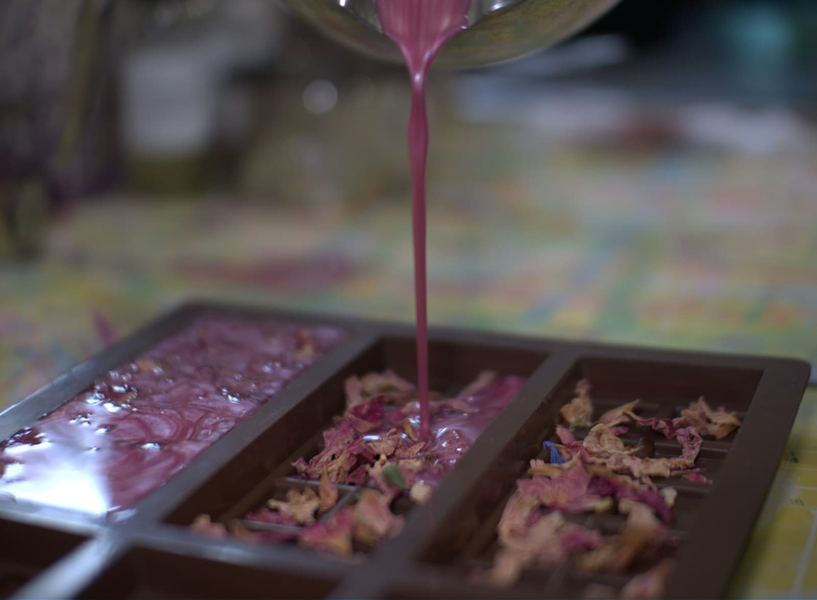 A pink mixture being poured into a mould
