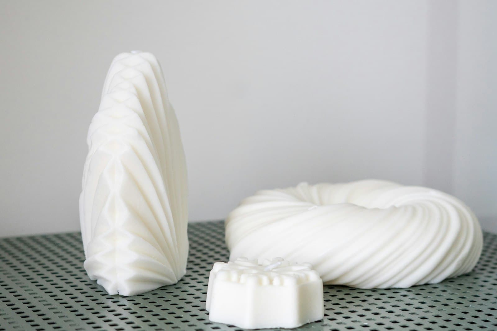 White cast sculptural pieces on a table