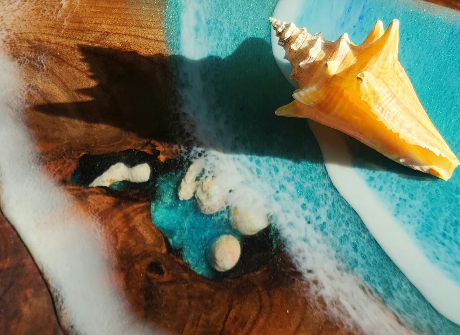 A shell resting on a wave-like epoxy surface