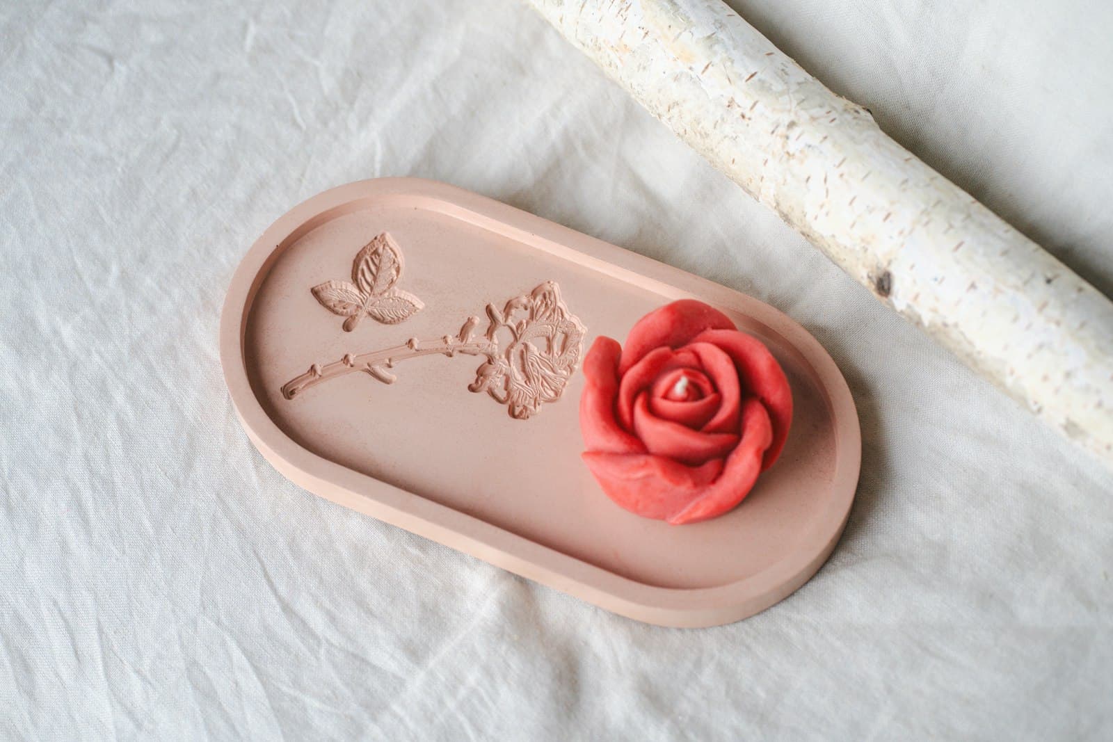 A cast rose on a cast decorative tray