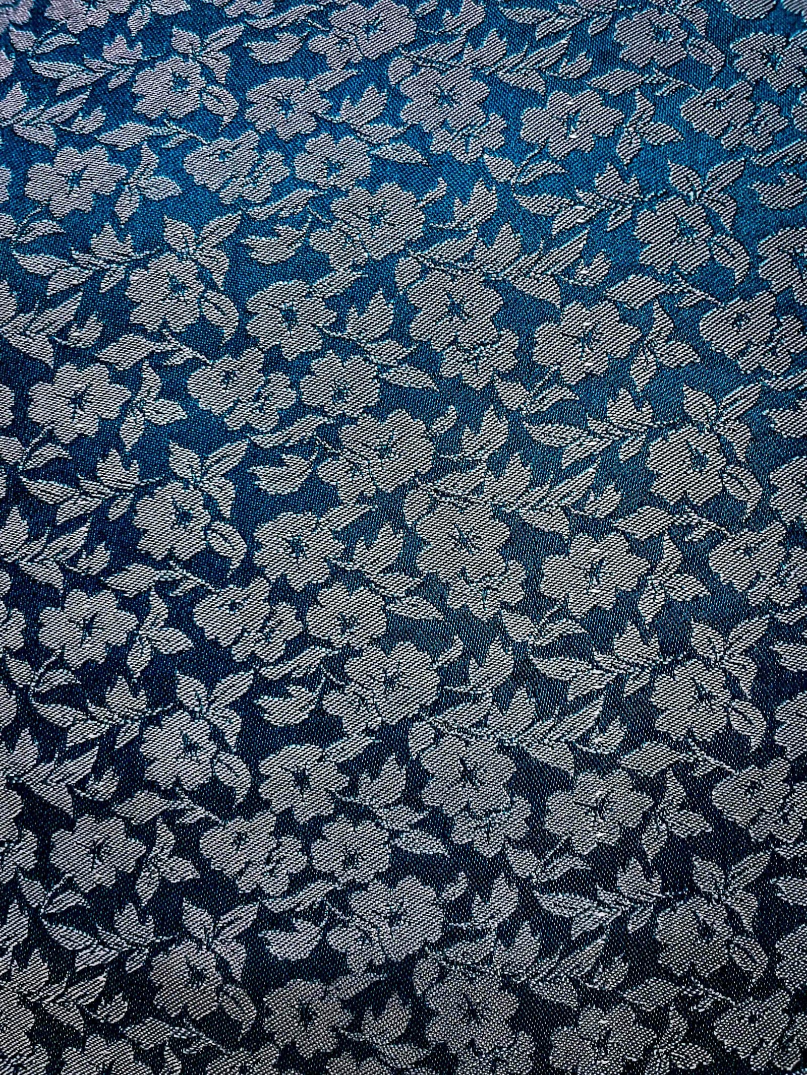 A continuous white floral repeat on blue