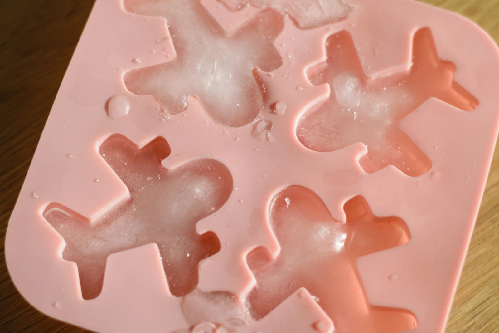A pink silicone mould with shaped cavities