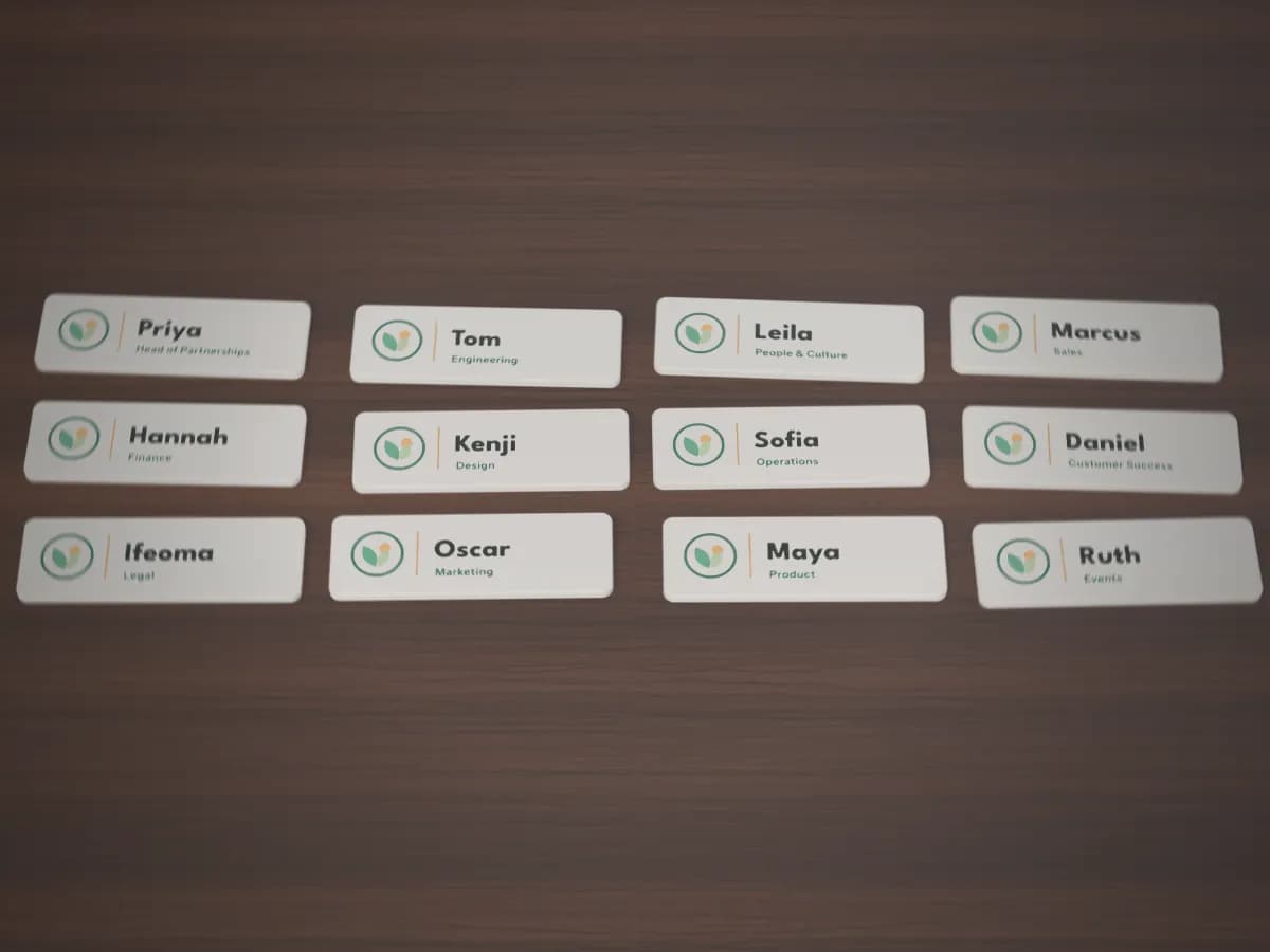 Twelve printed name badges, each with the same logo and a different name and job title