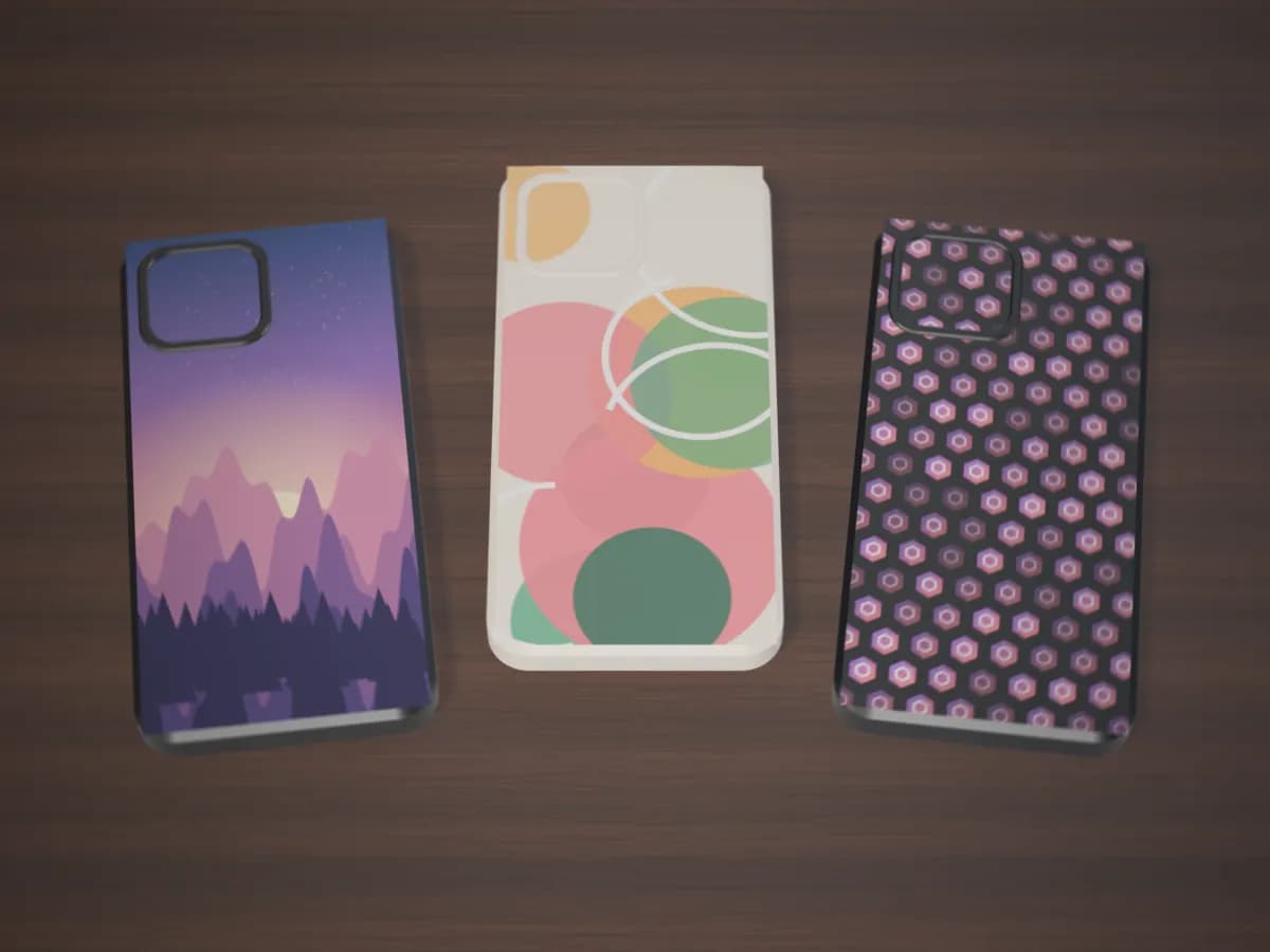 Three phone cases printed edge to edge: a landscape, bold circles and a pattern of logos