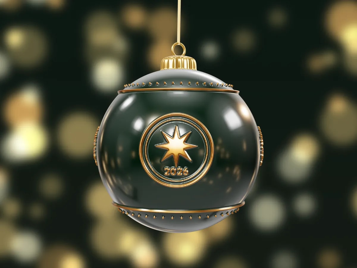 A glossy dark green bauble with a gold star emblem and 2026 in relief