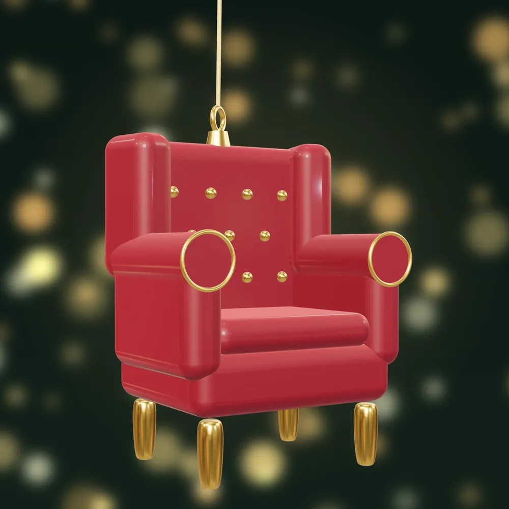 A miniature red wingback armchair bauble with gold buttons and gold legs