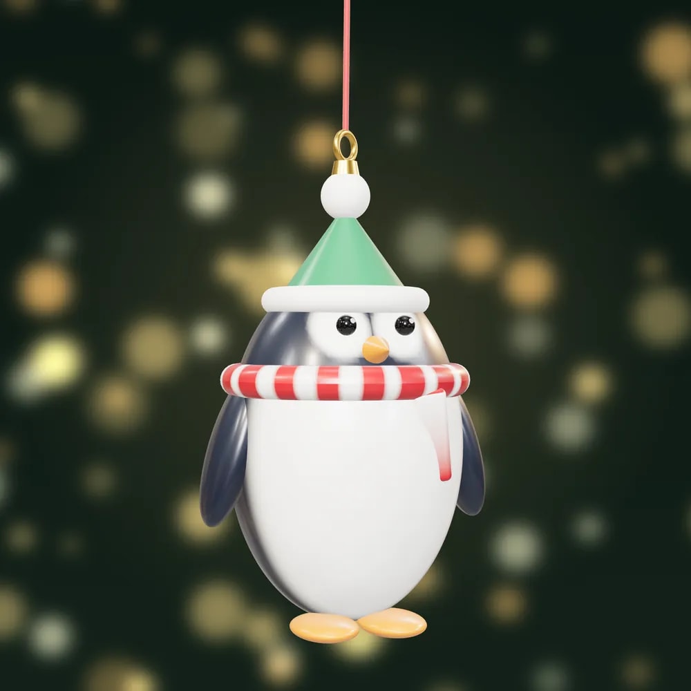 A hand-painted penguin bauble in a green bobble hat and a red and white striped scarf