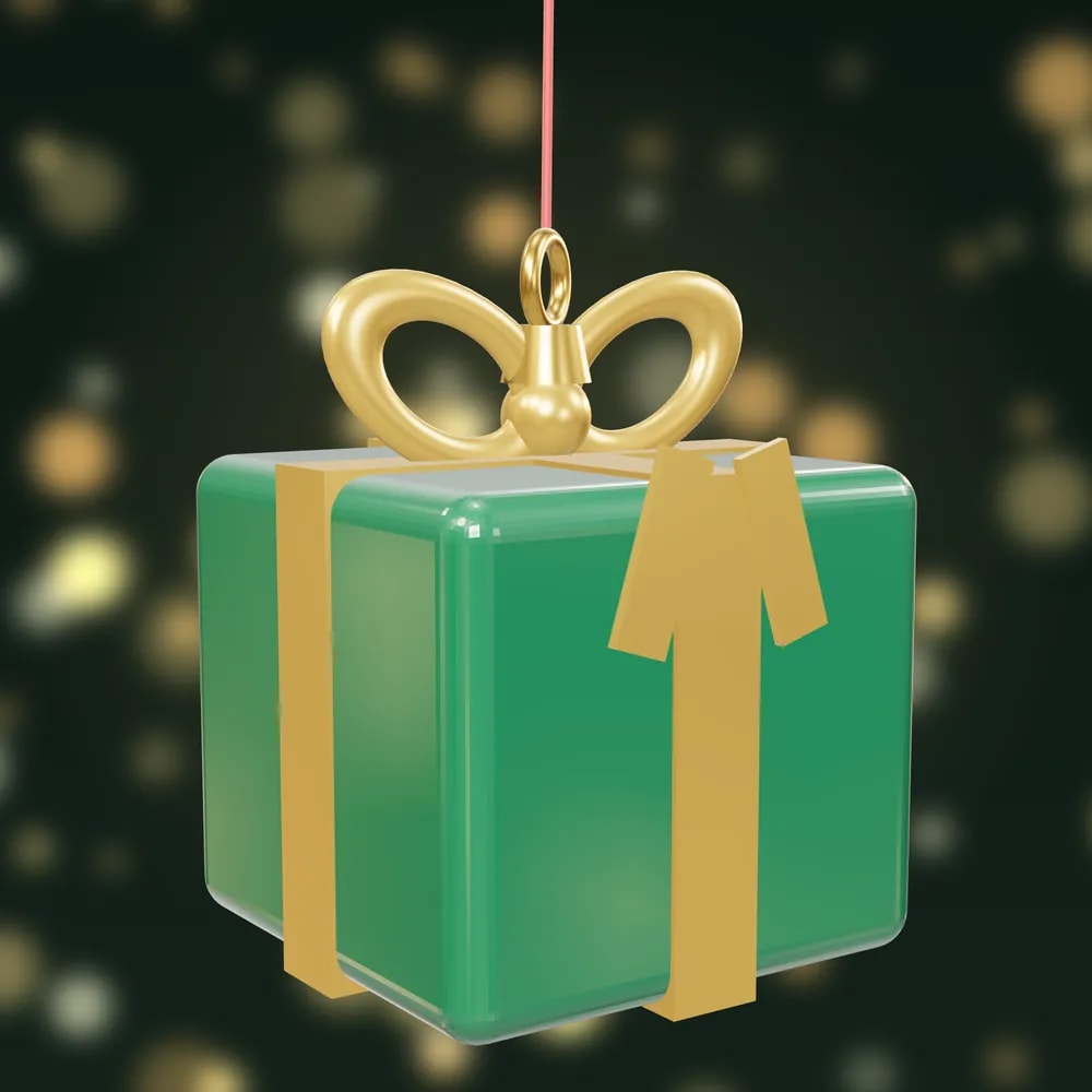 A glossy green present bauble with a gold ribbon and bow, painted with cream dots