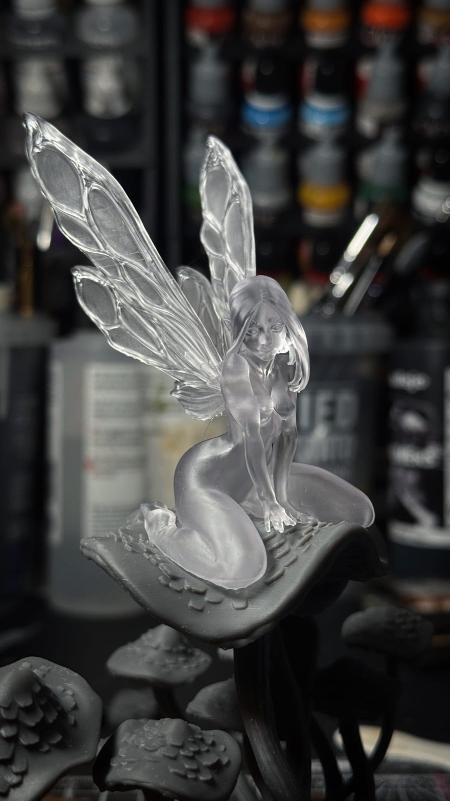 A fairy on a mushroom with wings printed in clear resin