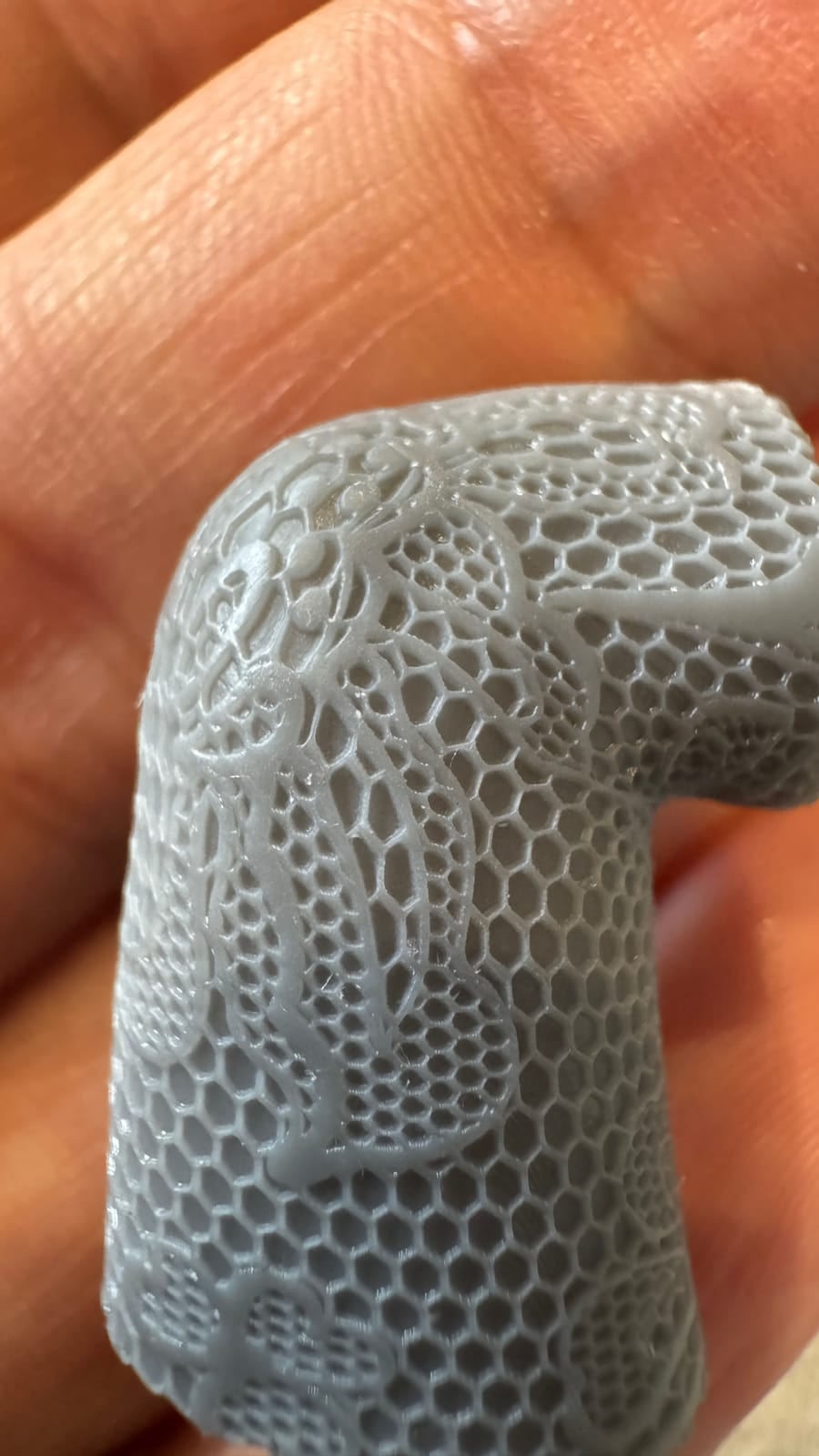 Close-up of a fine honeycomb texture printed in resin