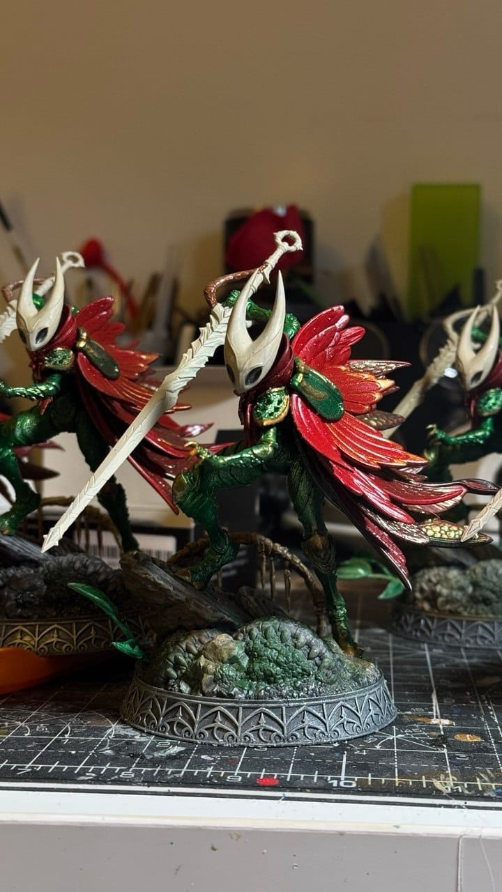 Hand-painted resin fantasy warriors in green and red on a sculpted base