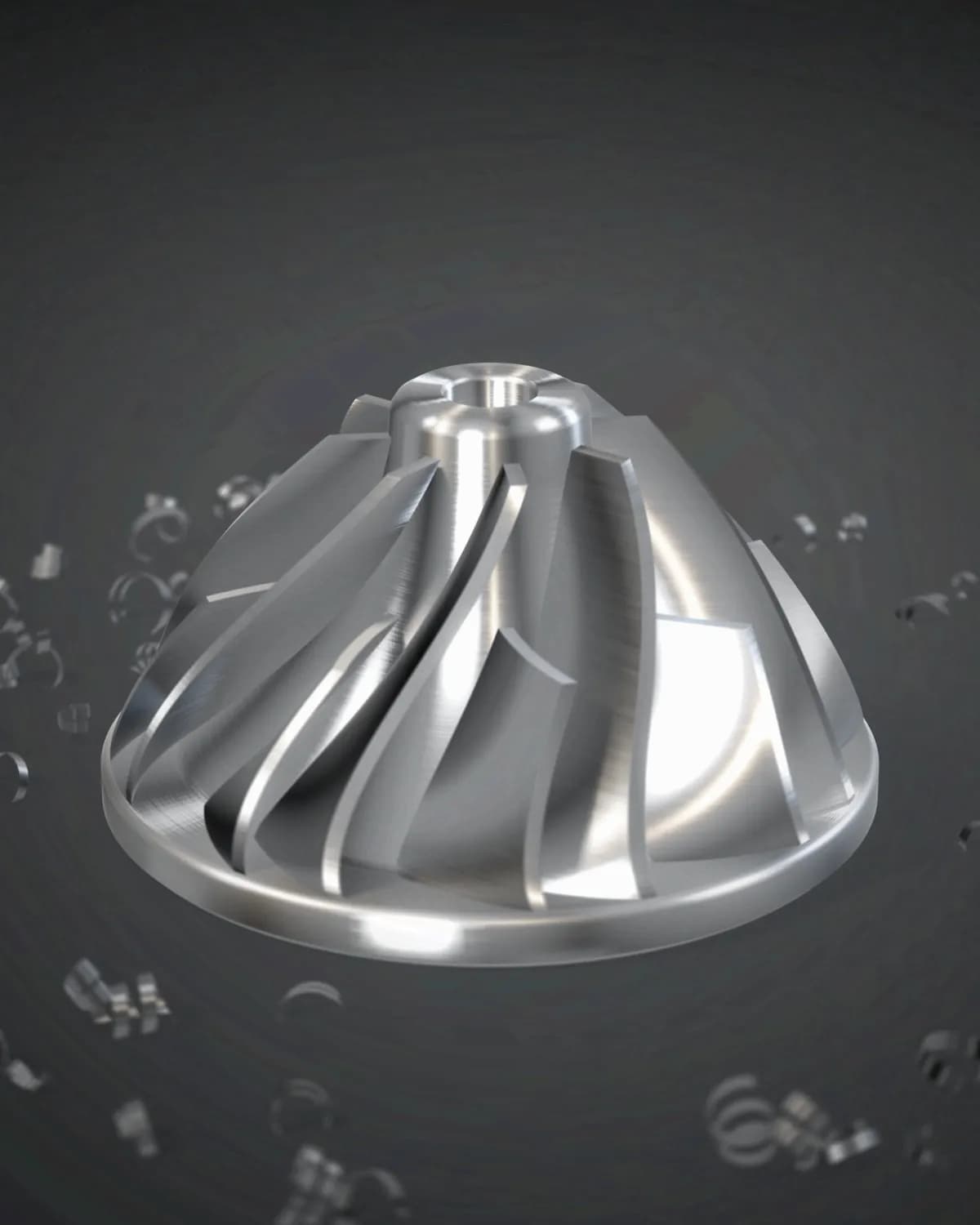 A five-axis CNC machined aluminium impeller standing on a dark steel bench among bright aluminium chips