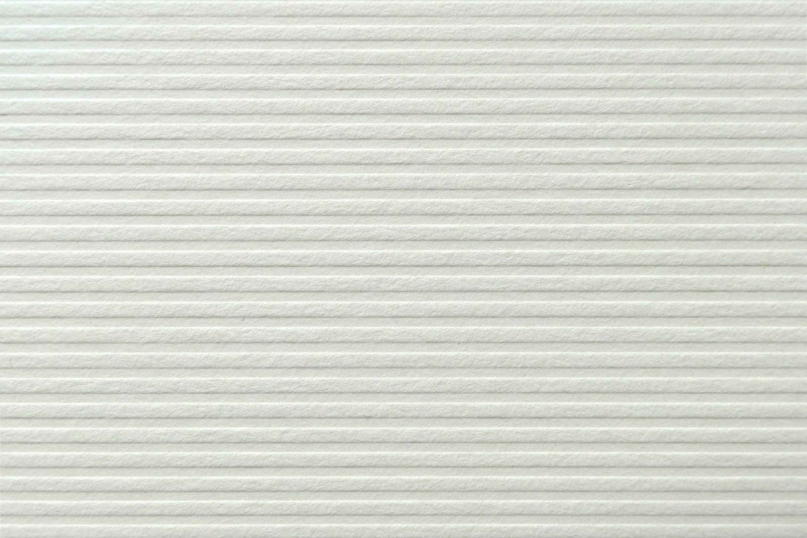 A fine ribbed texture across a white surface