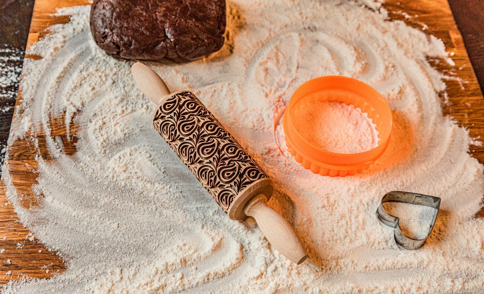 A patterned roller resting in flour