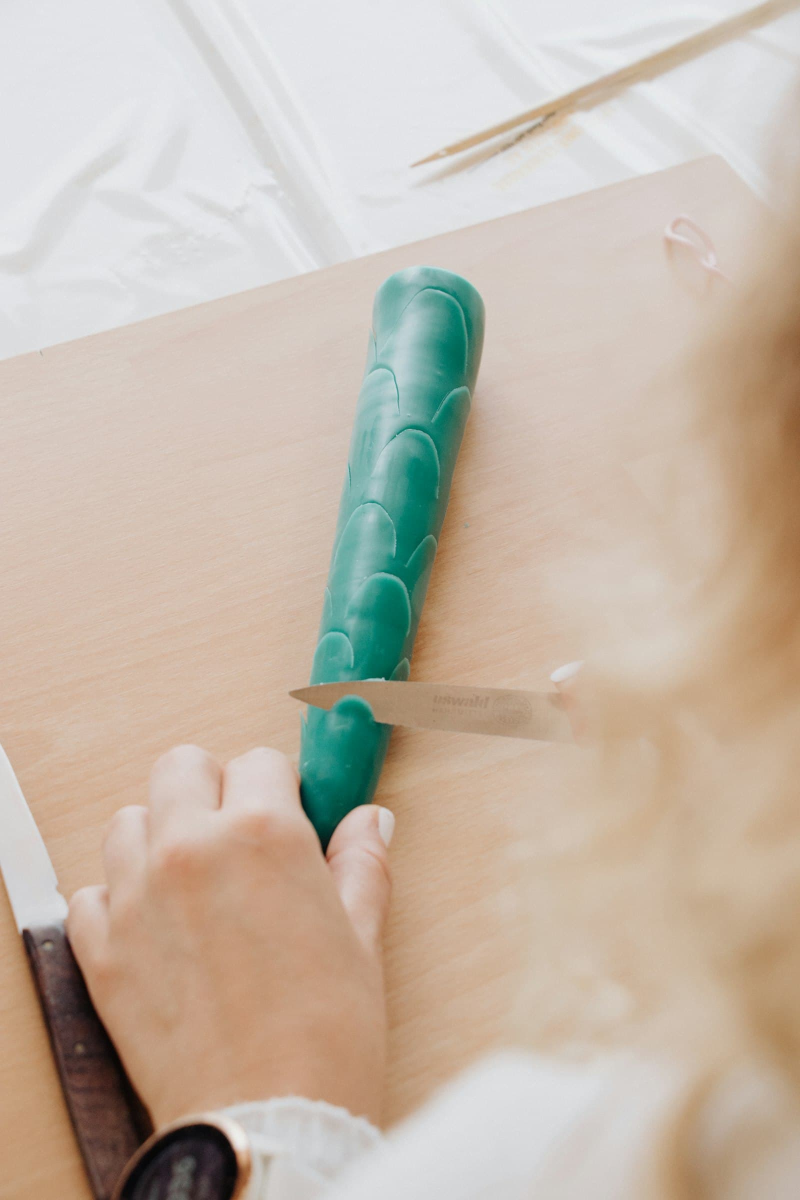Cutting a textured coil of green clay